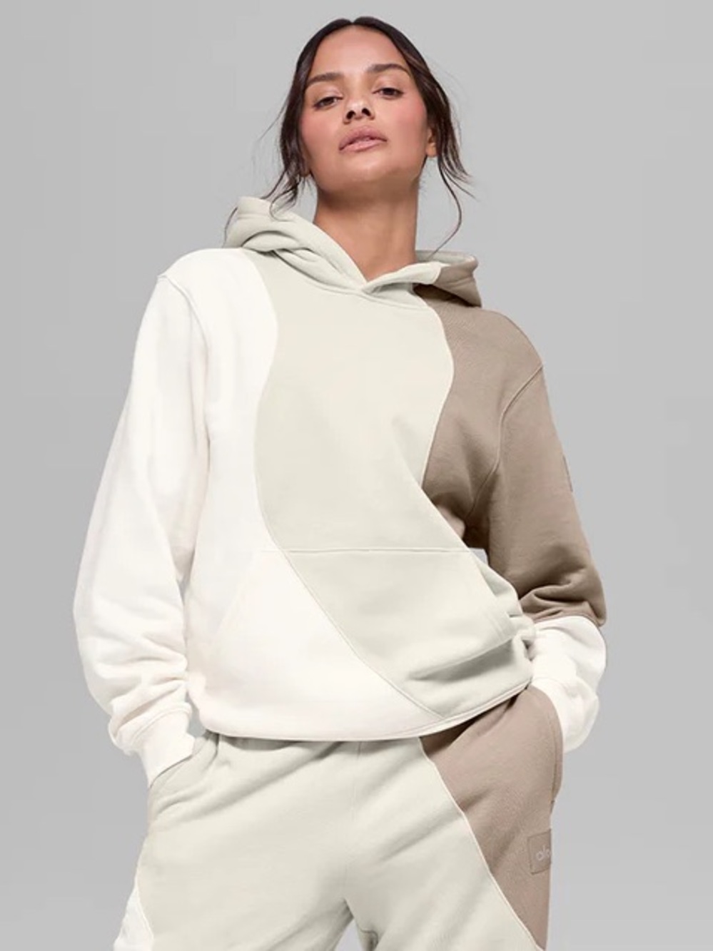 Alo Yoga Make Waves Hoodie in the Ivory/Bone/Gravel colorblock design.